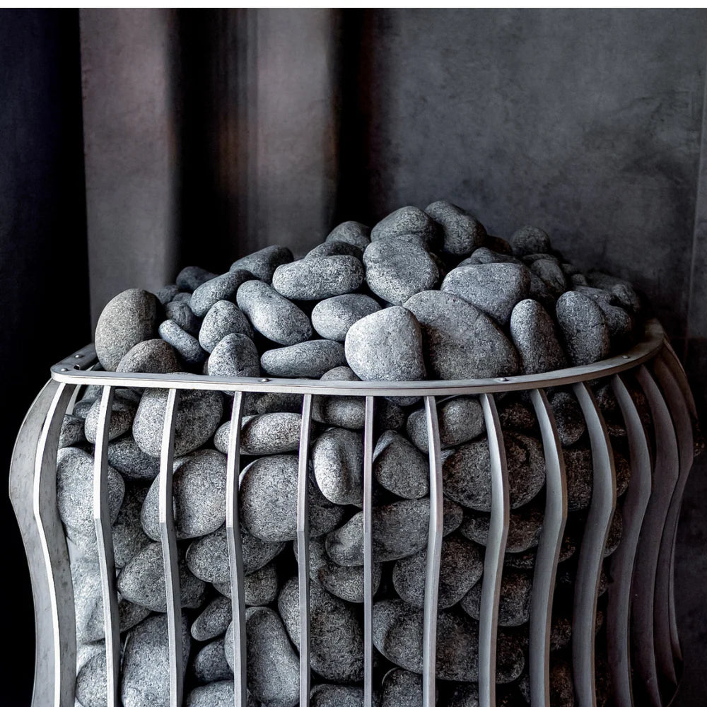 Decorative stone bowl filled with gray stones on a dark background