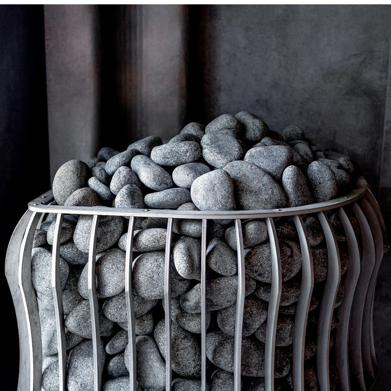 Decorative stone bowl filled with gray stones on a dark background